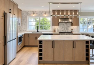 Warm wood kitchen renovation with custom cabinetry and large island by Avantte Interior Designs